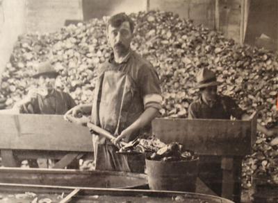 A man in the Muscatine shell-soaking room, about 1915. ALL PHOTOS COURTESY THE NATIONAL PEARL BUTTON MUSEUM