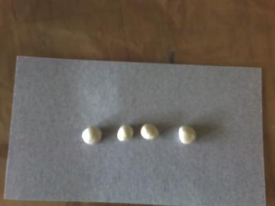 4 white crab pearls, each about a centimeter long