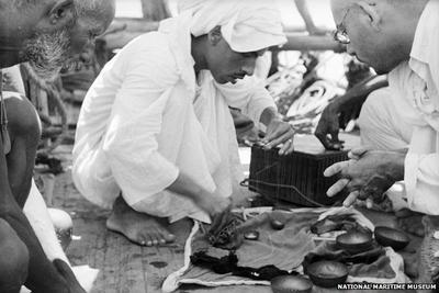 Pearl Merchant Examines Pearls on Board
