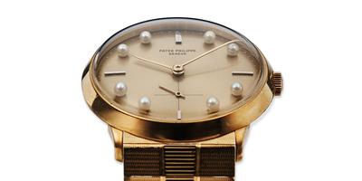 A very rare and impressive gold  Patek Philippe wristwatch with pearl hour markers.