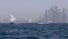 Dhows participate in the Al-Gaffal traditional long-distance dhow sailing race near the finish line off Dubai