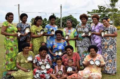 Women and some children of Raviravi in Macuata show their harvest of half-pearls